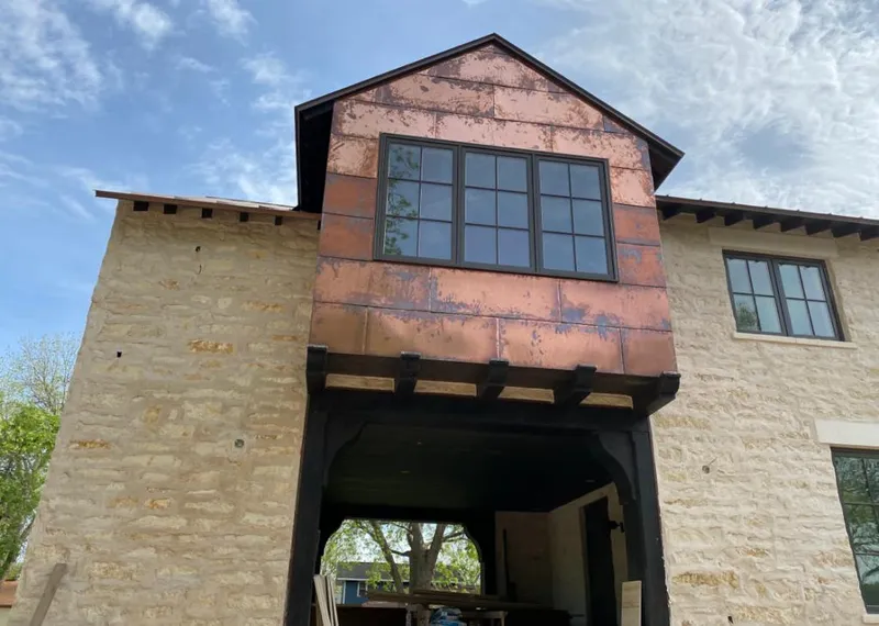 Copper metal panel facade on a stone building for Skylight Installation in Highwood